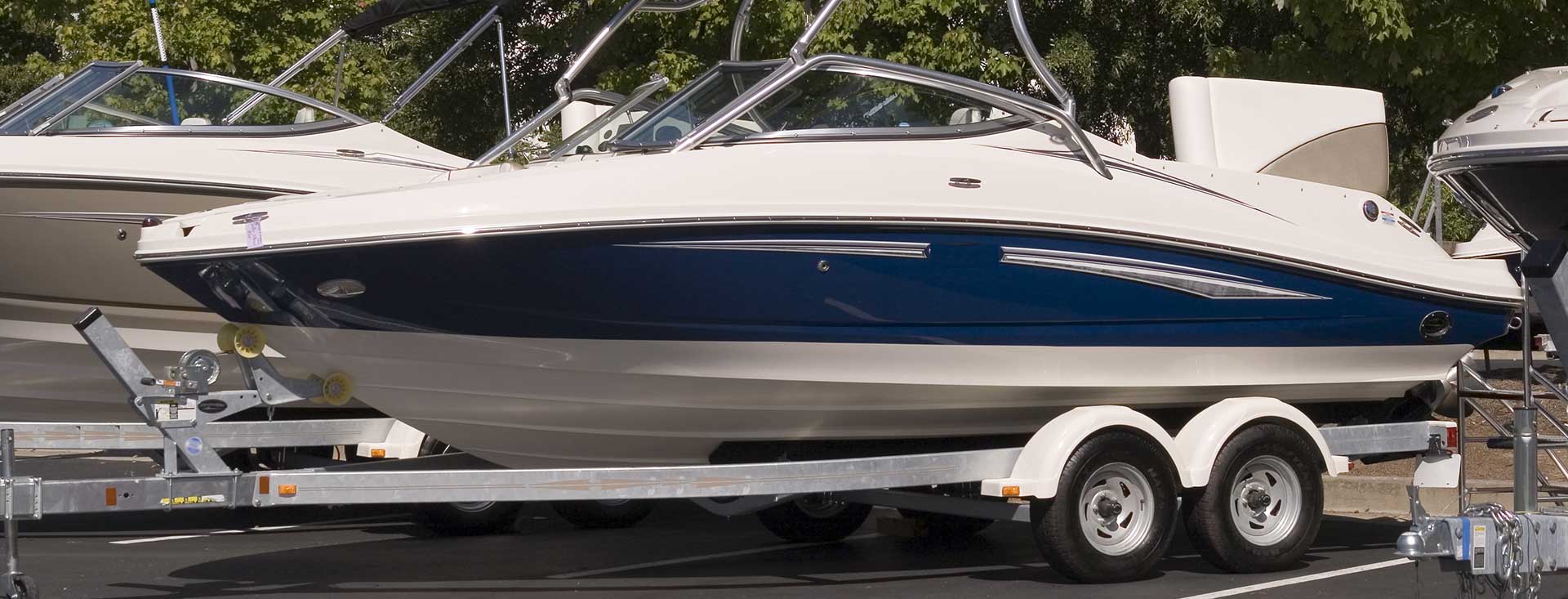 A blue and white speed boat in a parking spot