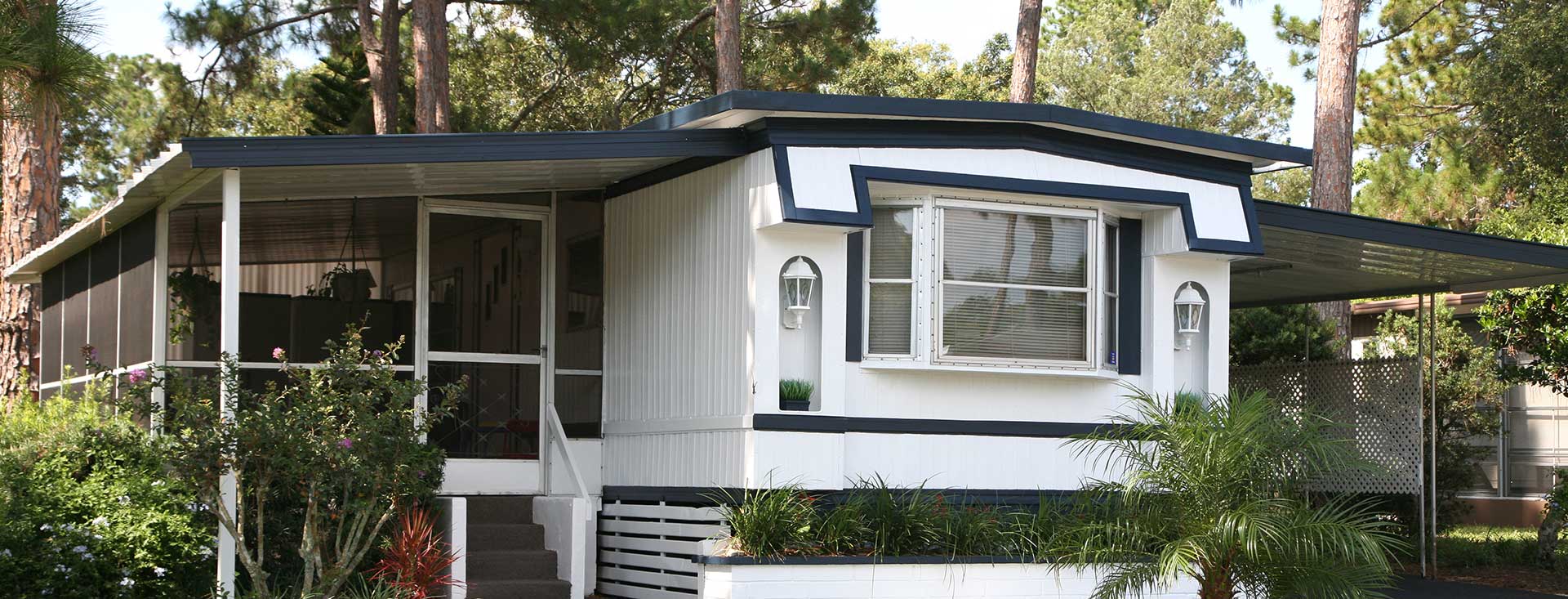 A mobile home with tropical trees and plants